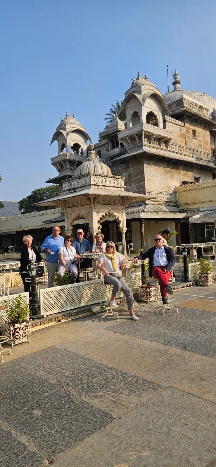 Travelers posing in the courtyard of a historic Rajasthani palace